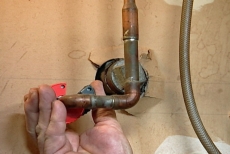 scoring the copper line with a pipe cutter