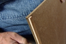 examining 1/4-inch hardboard edged with spacers on the back