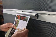 clasping a paper in a Slatwall Clip-It Strip