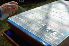 protecting a map with multi-surface waterproofer