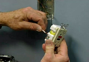 Man installing a GFCI Electrical Receptacle