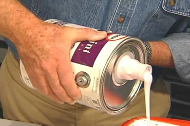 pouring paint from a paint-can