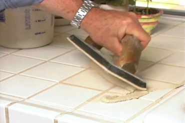 applying grout to the tile