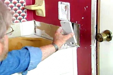 inserting a patch into the hole in the wall