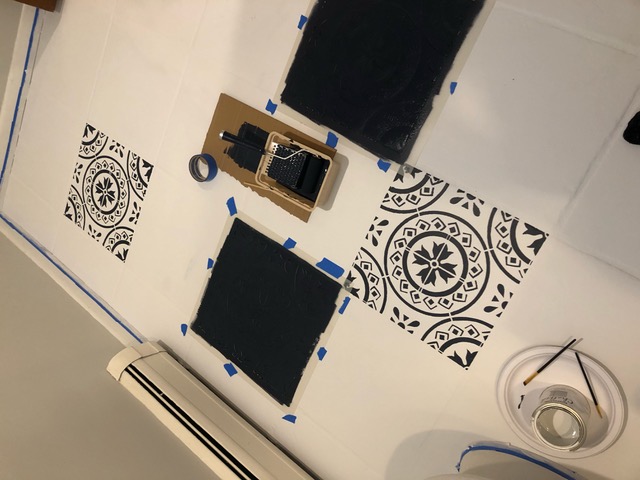 several floor stencils removed from tile and painted in black