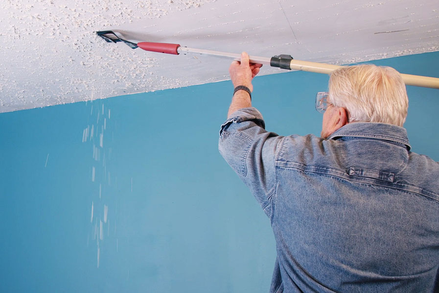 Man using Zenith Industries Floor Lifter to remove popcorn ceiling