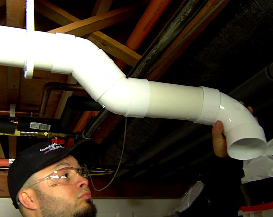 Man installing vent in basement 