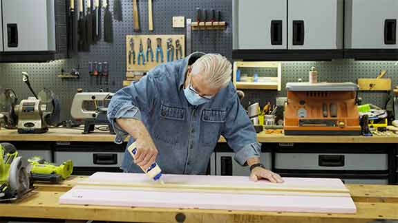 Man applies wood adhesive 