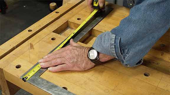 Man extending a tape measure