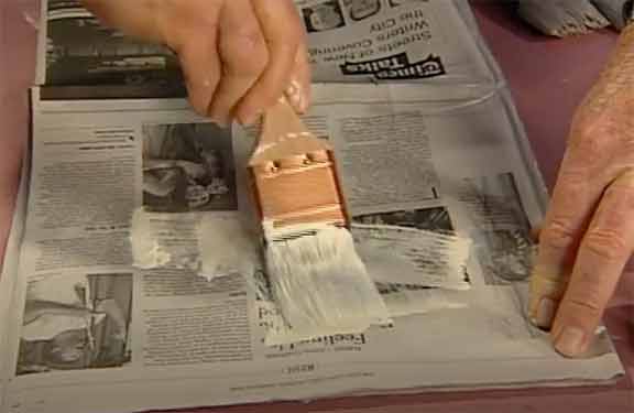Man painting newspaper