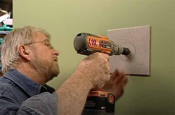 Man uses carbide grit hole-saw
