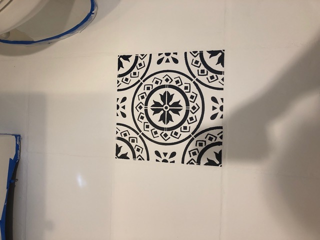 floor stencil removed from tile and painted in black
