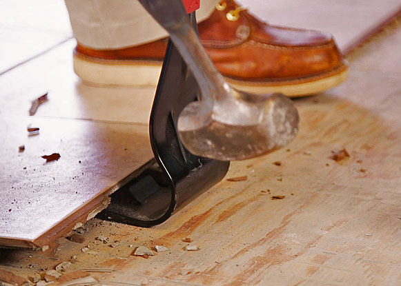 Man using Zenith Industries Floor Lifter to remove ceramic tile 