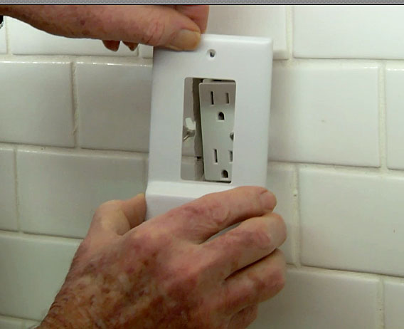 Man placing snappower over outlet