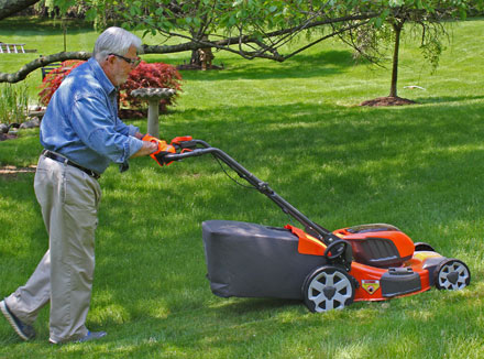 Man pushing lawn mower