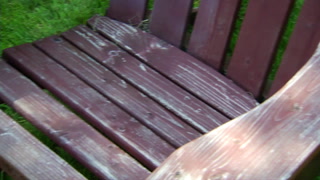 Adirondack chair with peeling stain/paint in need of restoration 