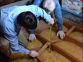 2 men insulating attic