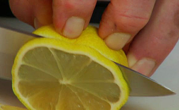 slicing a lemon with a sharp knife