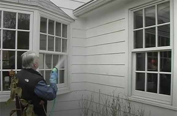 Man cleaning siding